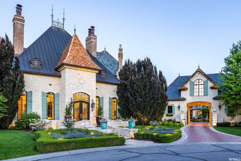 French country home with a front yard