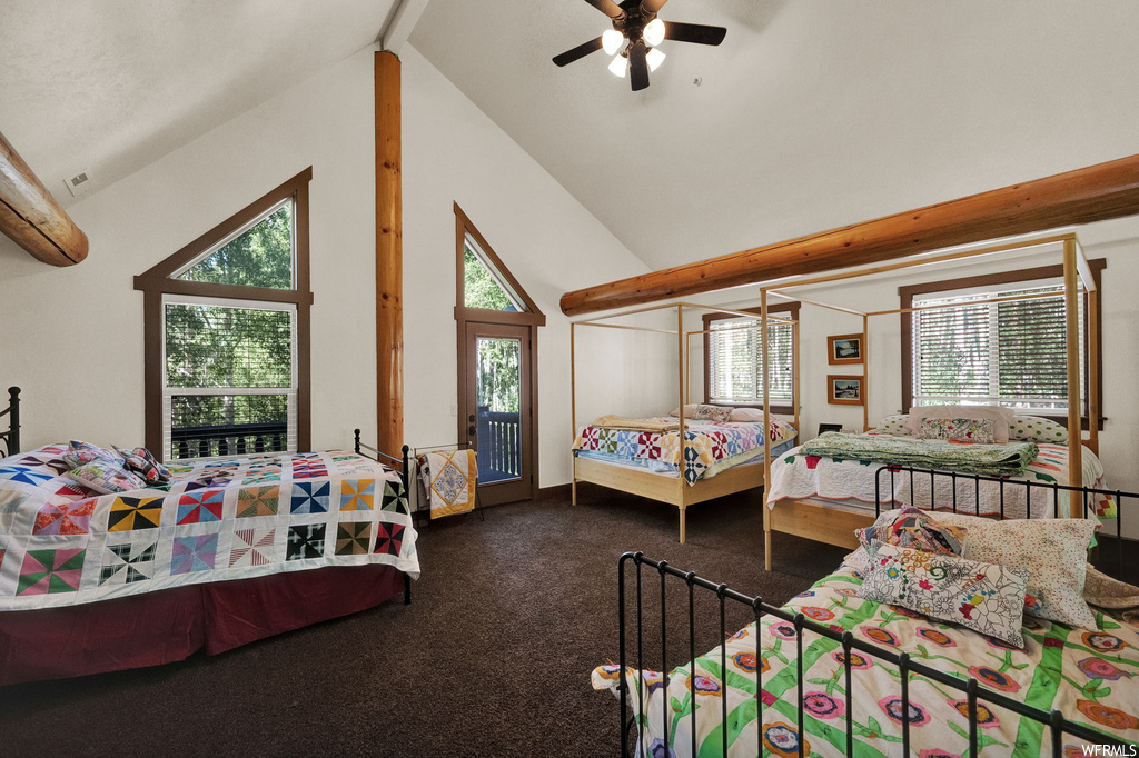 Carpeted bedroom featuring a ceiling fan, lofted ceiling, and multiple windows