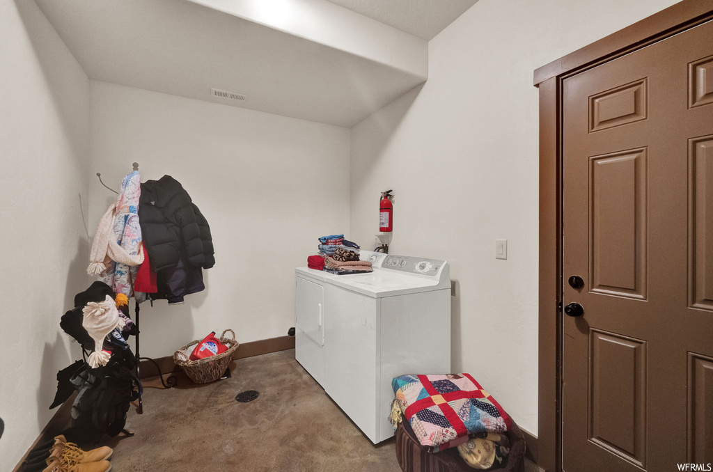 Clothes washing area featuring washer / dryer