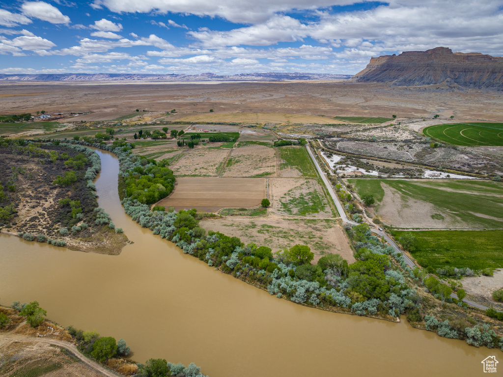 Birds eye view of property with a water and mountain view