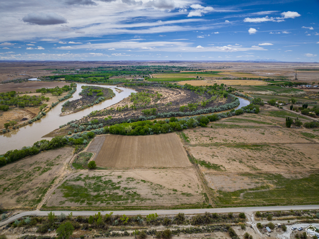 Birds eye view of property with a rural view and a water view