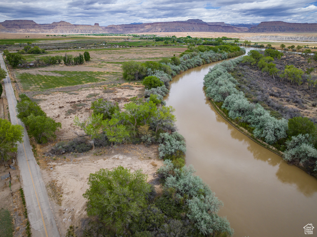 Birds eye view of property featuring a water and mountain view