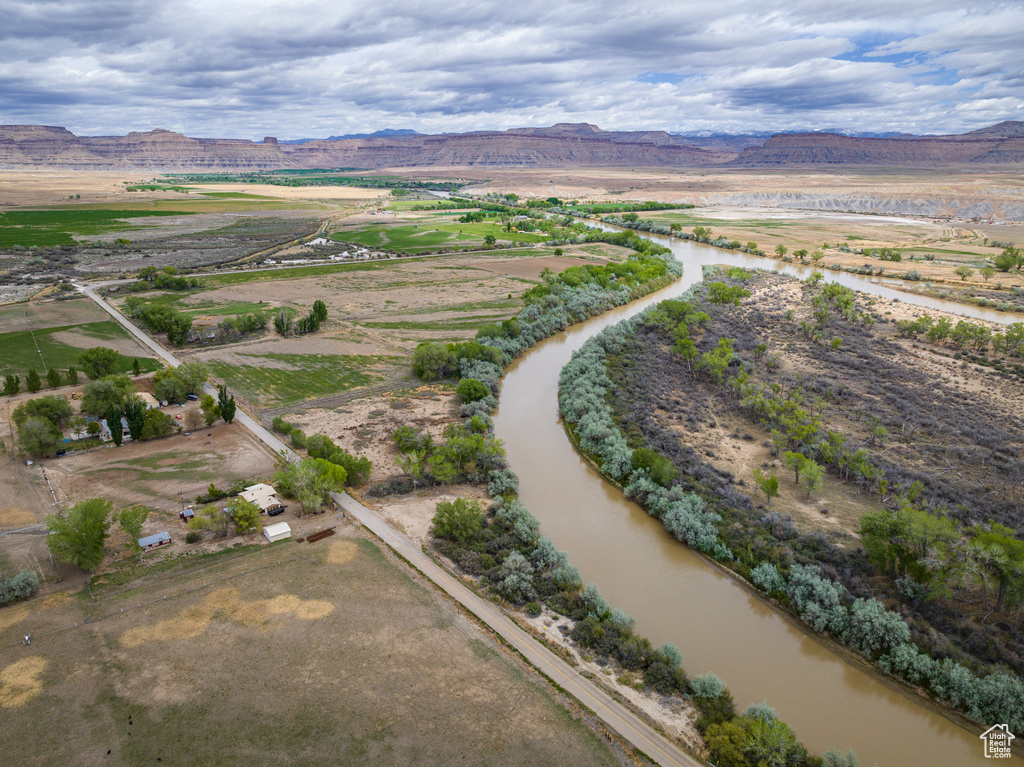 Birds eye view of property with a water and mountain view