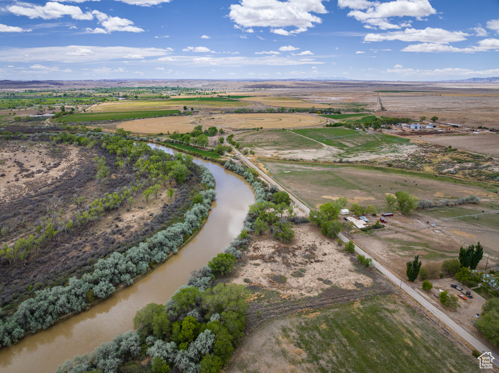 Birds eye view of property with a rural view and a water view