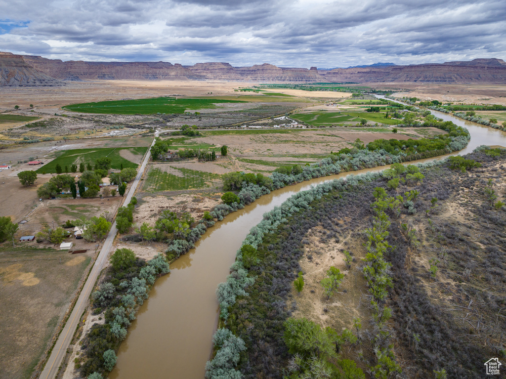 Drone / aerial view featuring a water and mountain view and a rural view