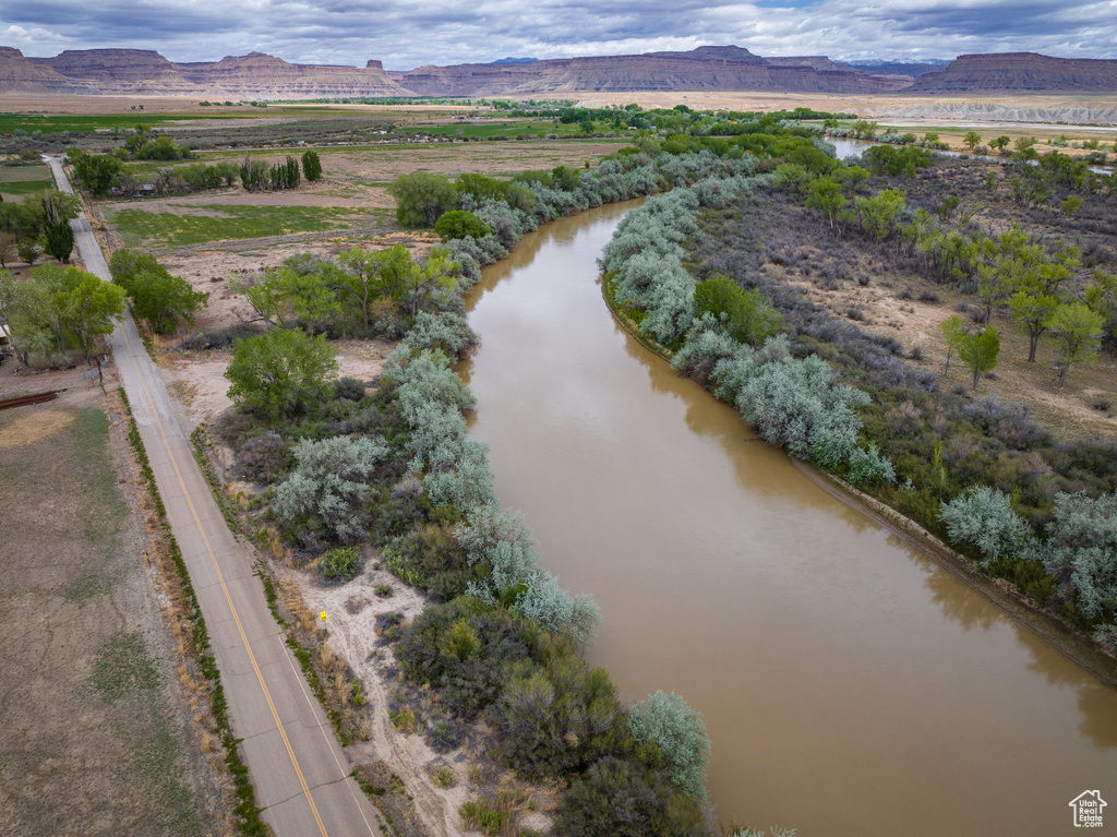 Birds eye view of property featuring a water and mountain view