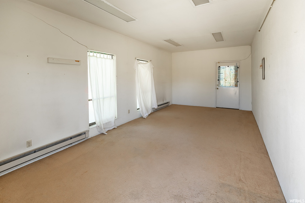 Carpeted empty room with natural light