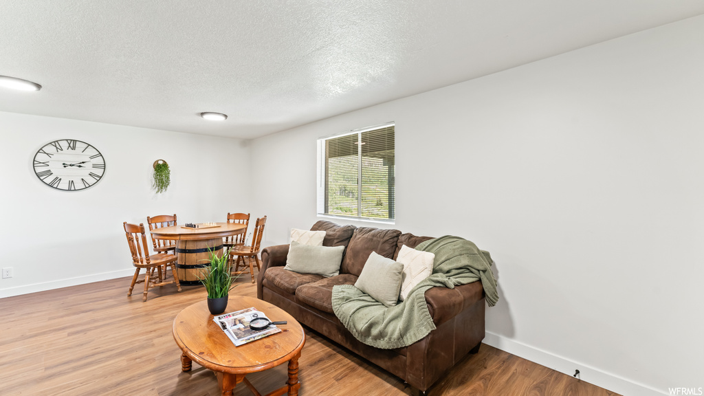 Hardwood floored living room with natural light