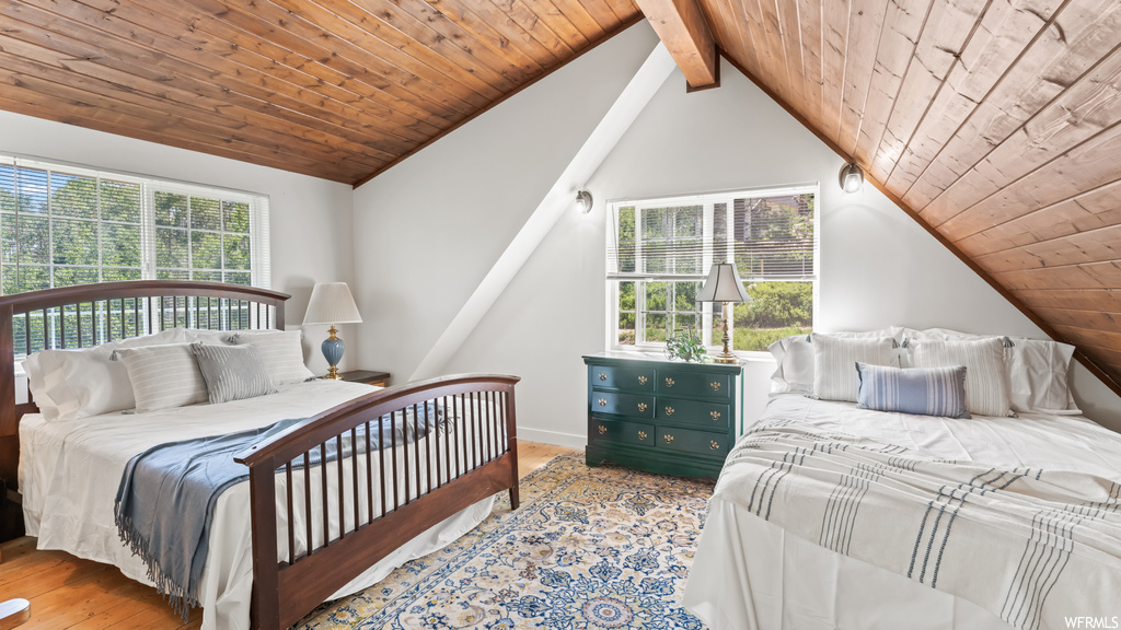Bedroom featuring multiple windows and lofted ceiling