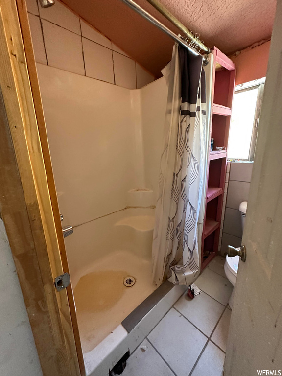Bathroom with shower curtain and toilet