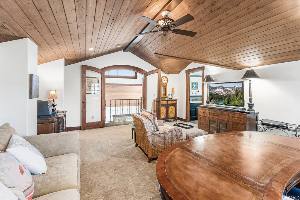 Living room featuring vaulted ceiling, natural light, a ceiling fan, and TV