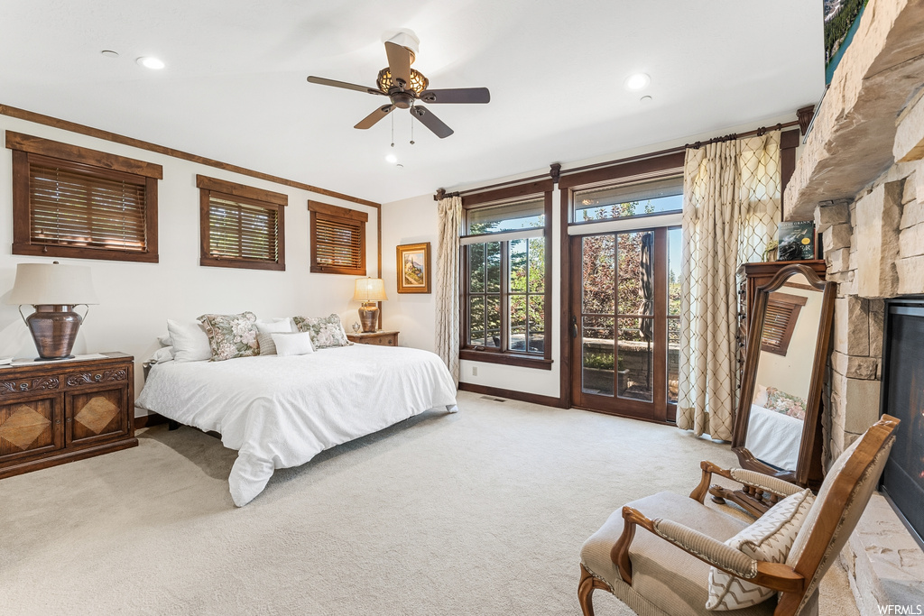 Bedroom featuring carpet, a ceiling fan, and natural light