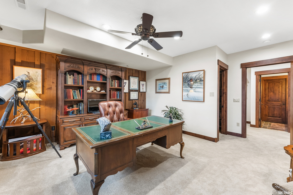 Office area featuring a ceiling fan and carpet