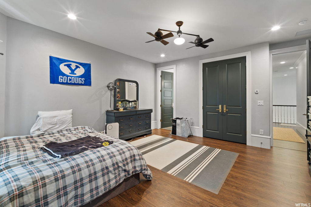 Bedroom with a ceiling fan and hardwood flooring