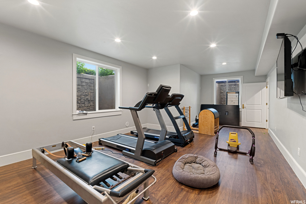 Exercise room with hardwood floors and natural light