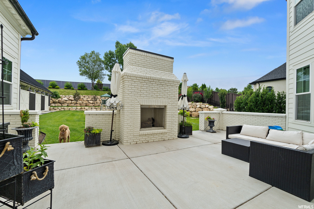 View of patio / terrace featuring an outdoor fireplace
