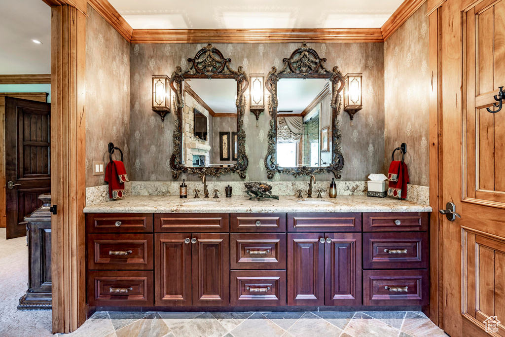 Bathroom featuring crown molding, tile floors, and dual vanity