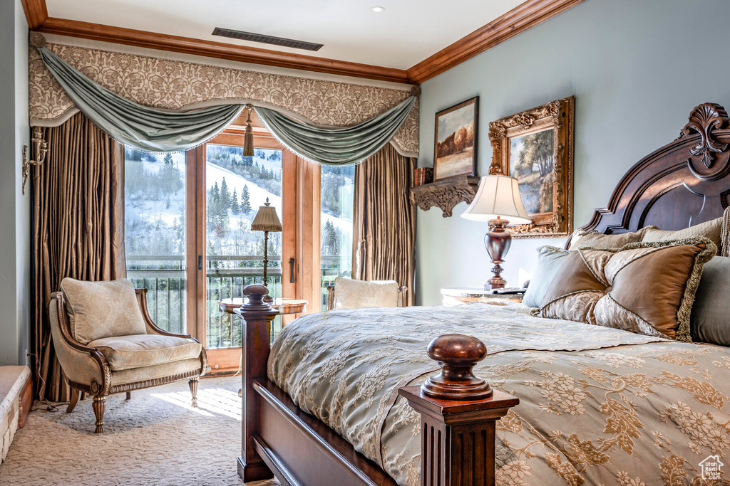 Bedroom with access to exterior, ornamental molding, and carpet
