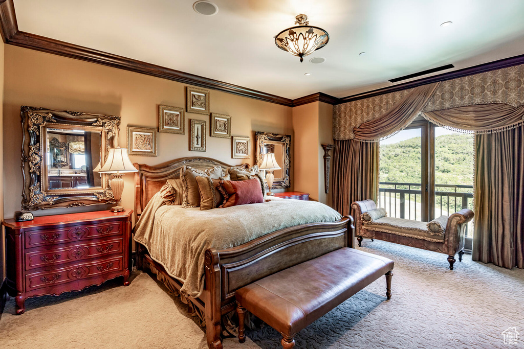 Bedroom featuring crown molding, light colored carpet, and access to outside
