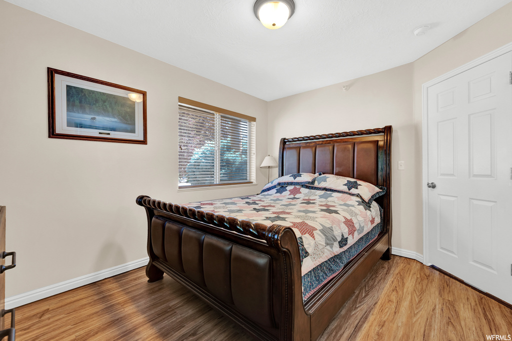 Hardwood floored bedroom with natural light