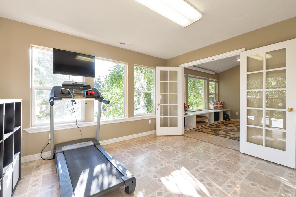 Workout room featuring plenty of natural light and TV