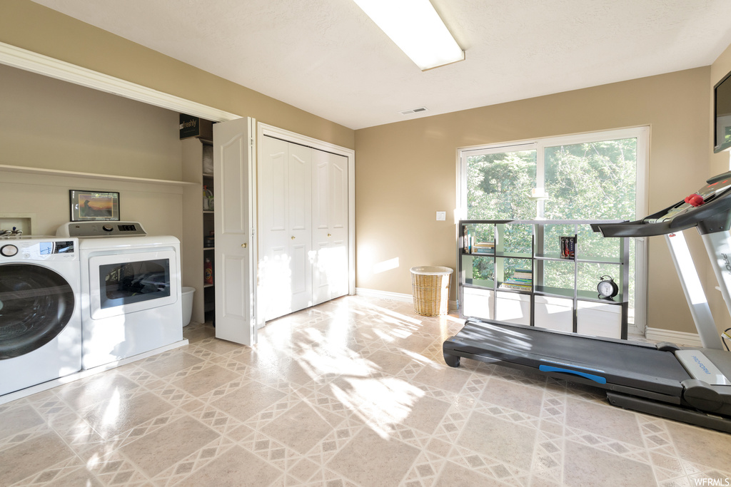 Laundry room featuring natural light and separate washer and dryer