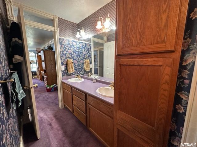 Bathroom featuring his and hers vanity and mirror
