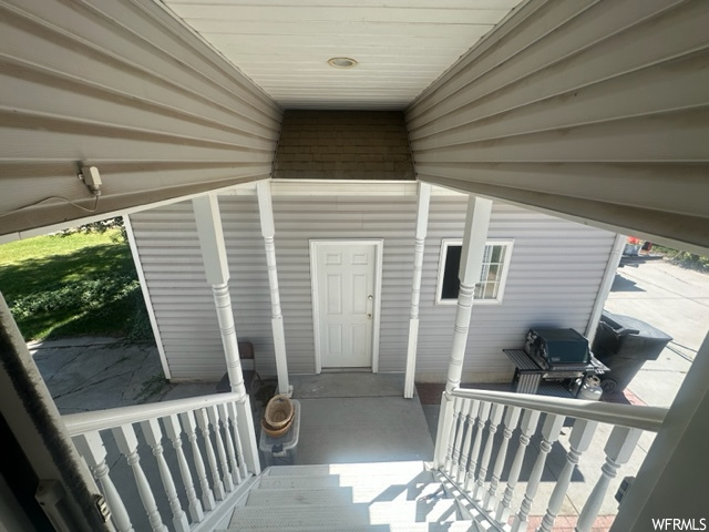 View of exterior entry with a deck