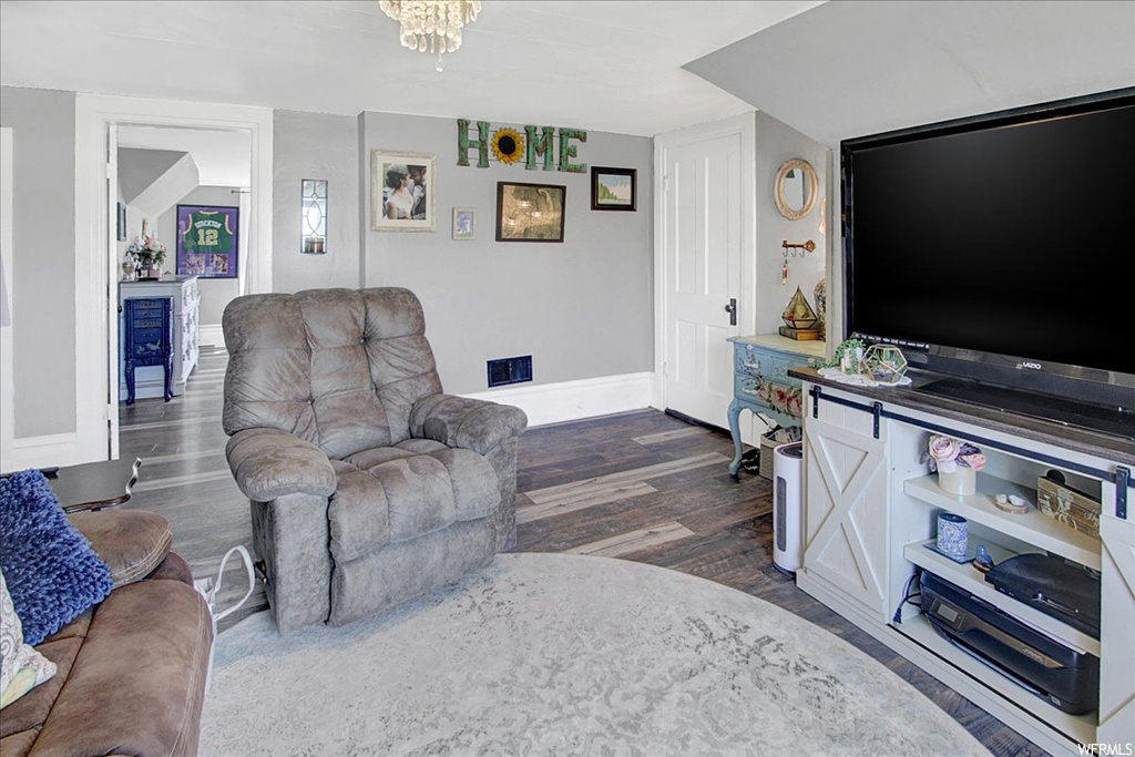 Hardwood floored living room with TV