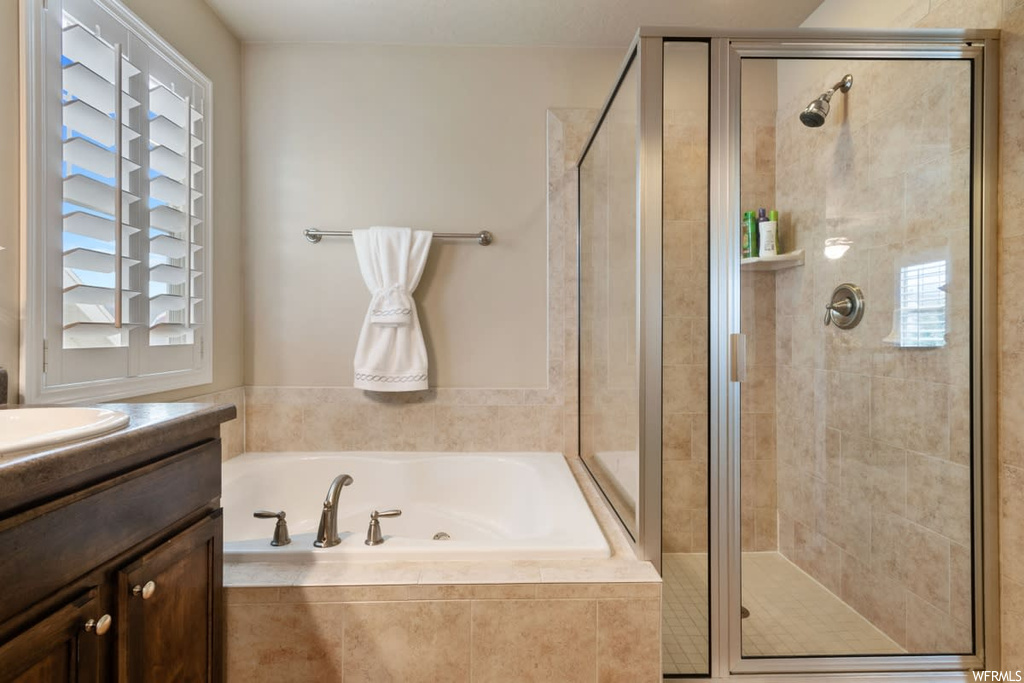 Bathroom with vanity and separate shower and tub