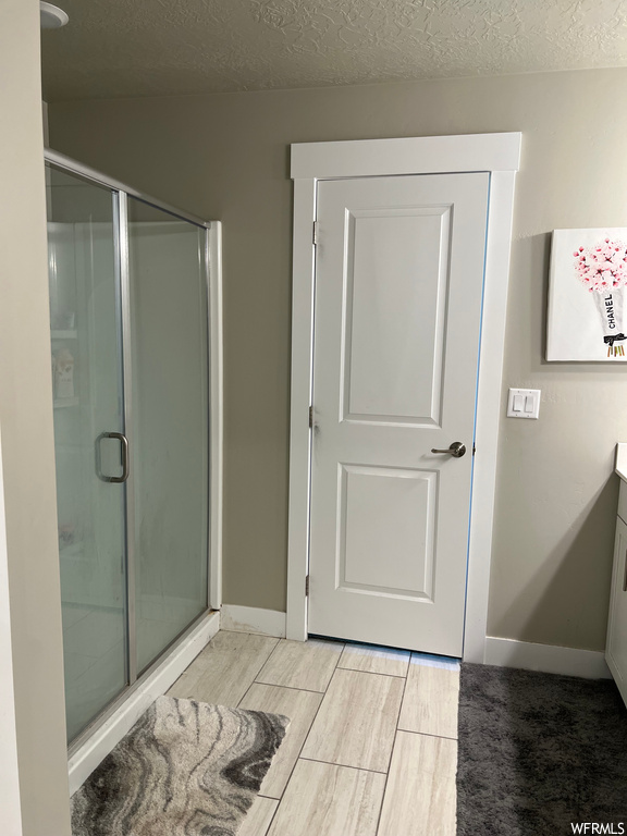 Bathroom featuring vanity and shower with shower door