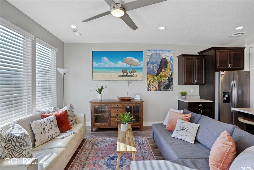 Living room featuring hardwood floors, a ceiling fan, and TV