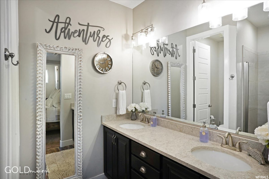 Bathroom featuring double sink vanity and mirror
