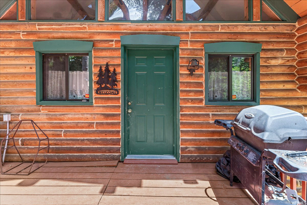 Doorway to property with a deck