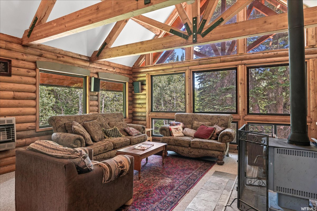 Living room featuring natural light and lofted ceiling with beams