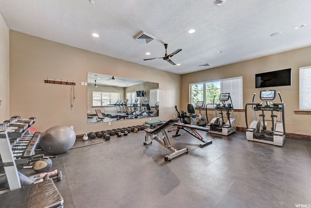Exercise room featuring TV and a textured ceiling