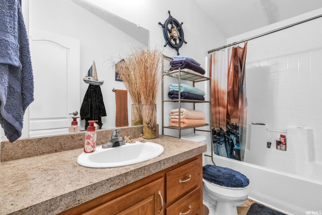 Full bathroom with oversized vanity, shower / tub combo with curtain, and mirror