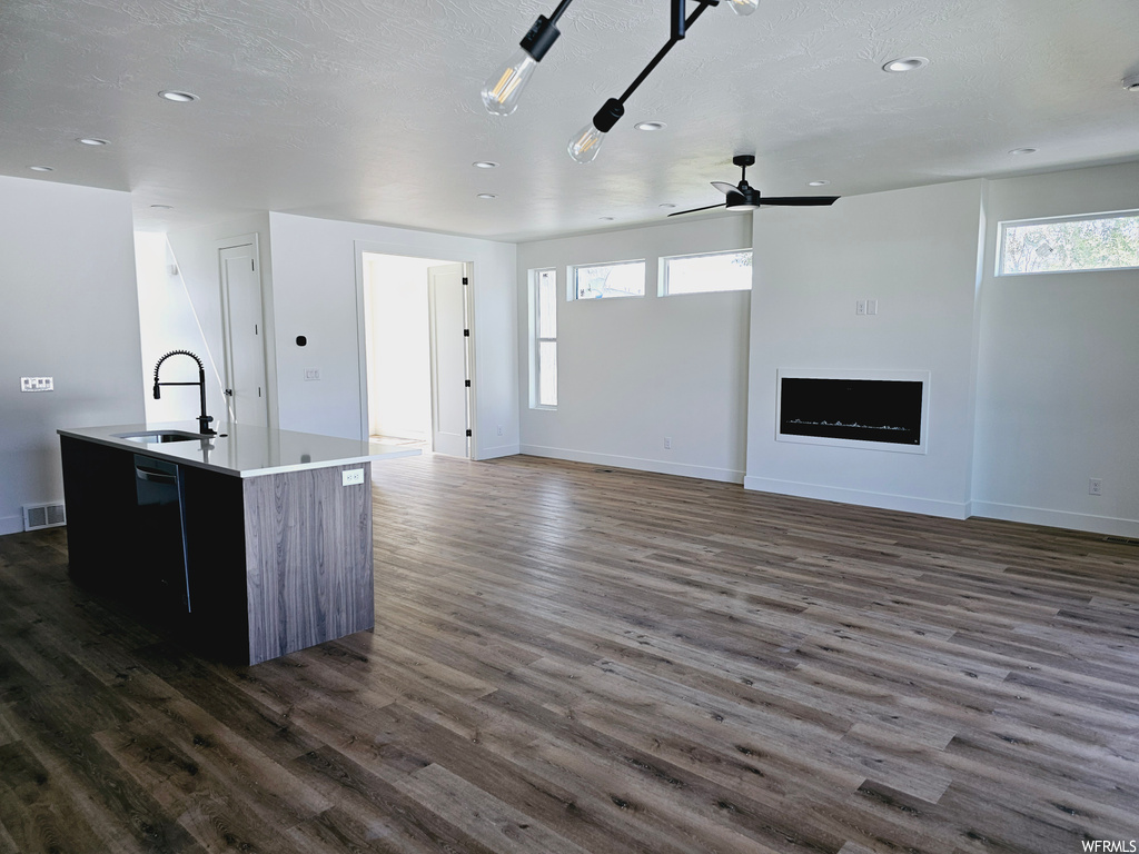 Kitchen with ceiling fan, a textured ceiling, a healthy amount of sunlight, and light parquet floors