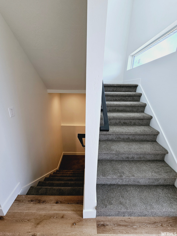 Stairway with light hardwood floors