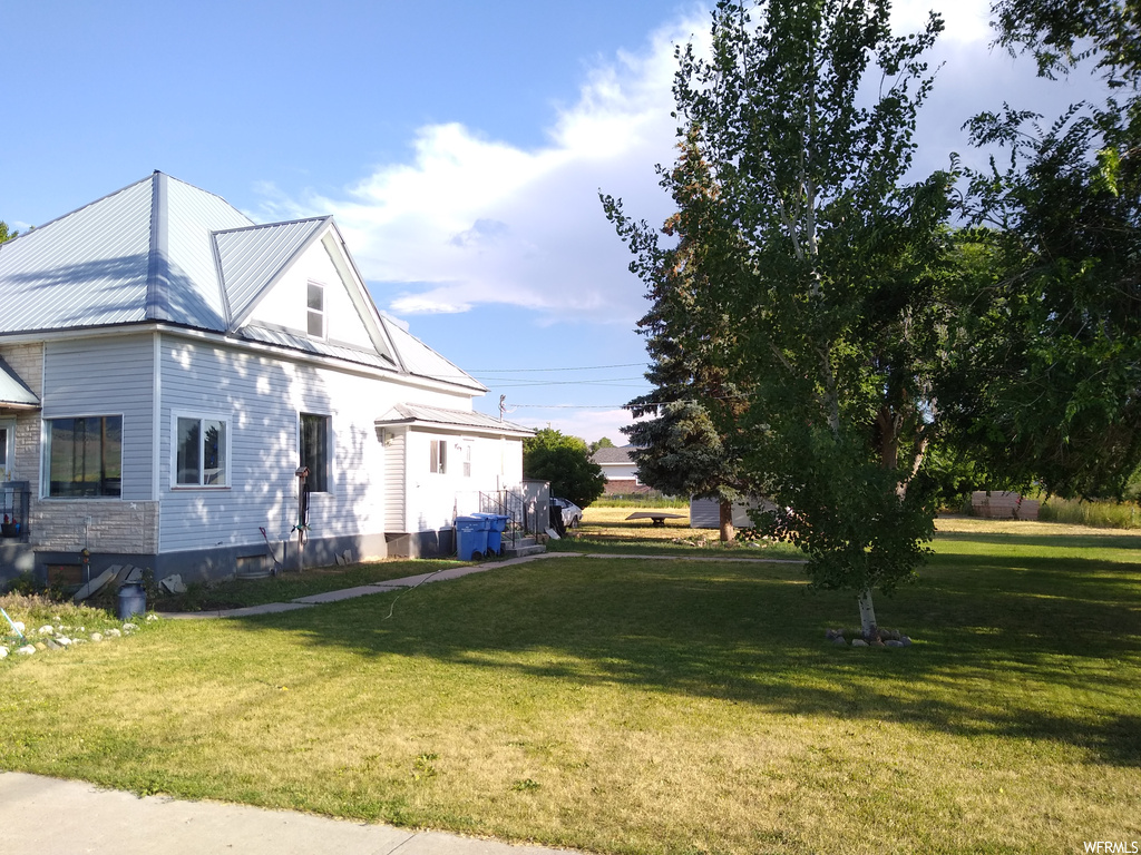 View of side of property with a yard