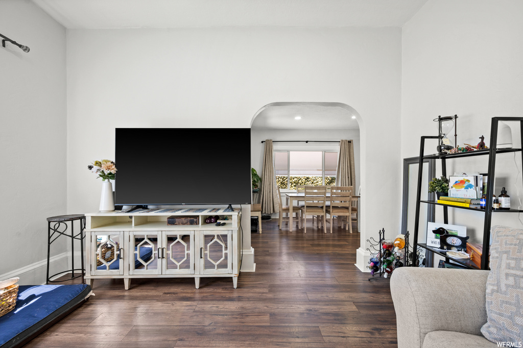 Living room with dark hardwood flooring and TV
