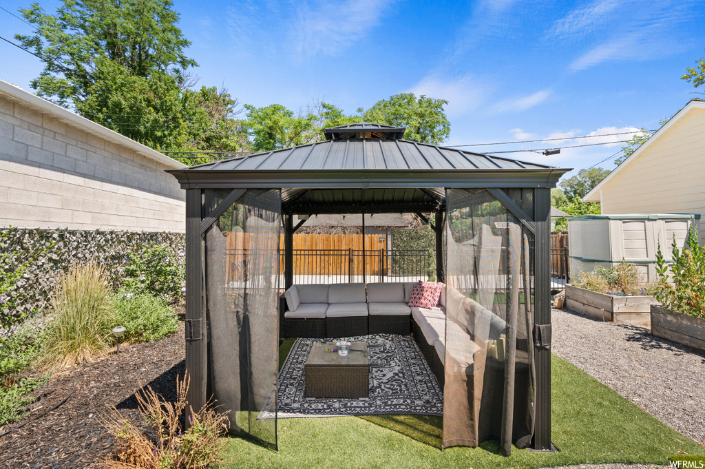 Exterior space featuring an outdoor living space and a gazebo