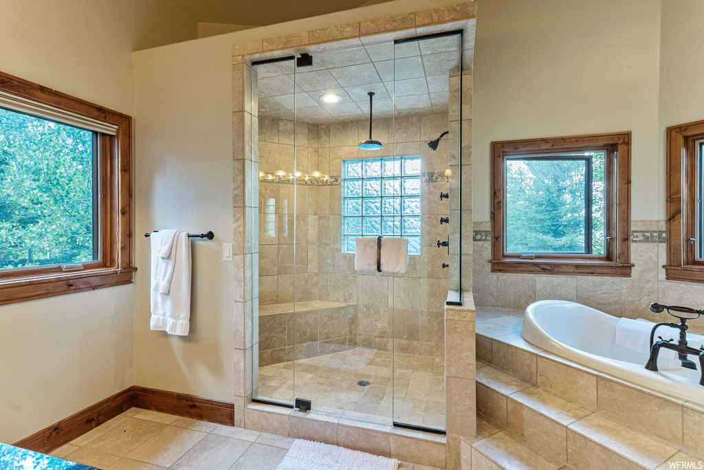 Bathroom with separate shower and tub and light tile floors