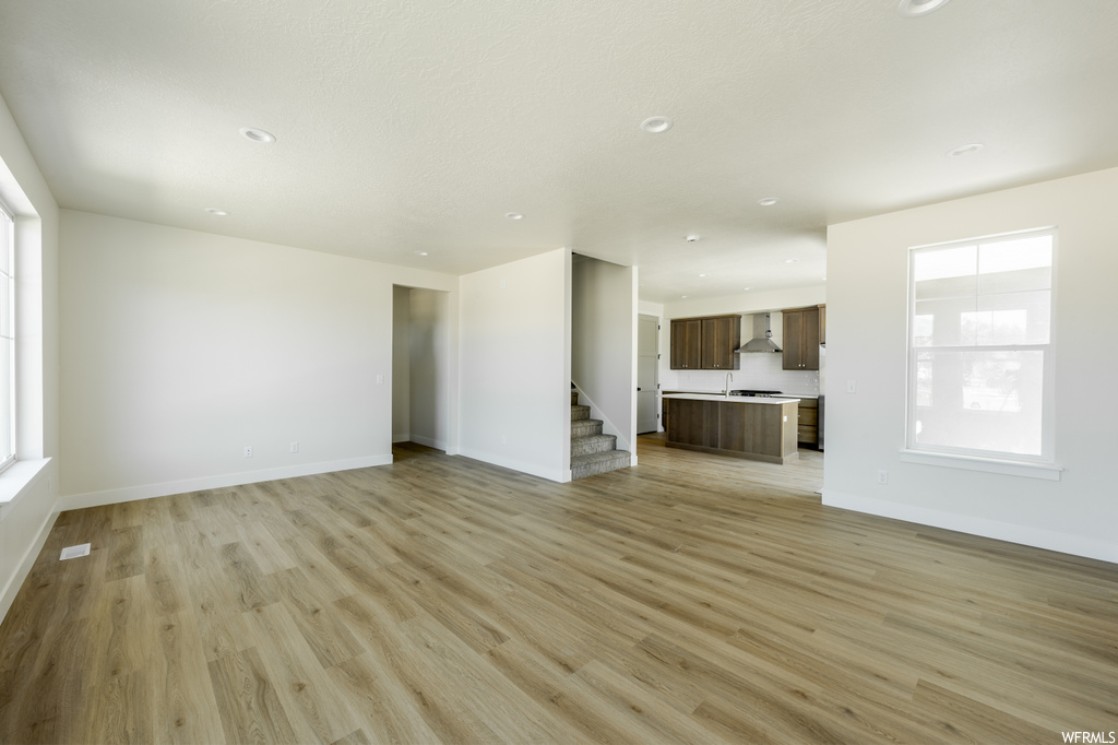 Hardwood floored living room with a wealth of natural light