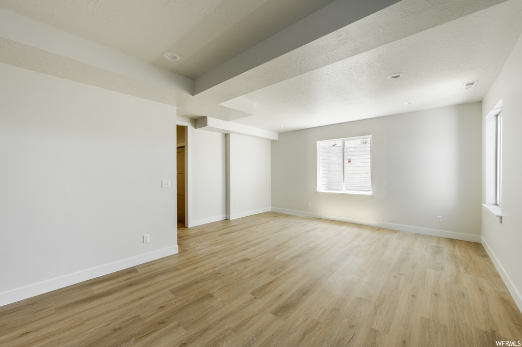 Unfurnished room with light hardwood floors