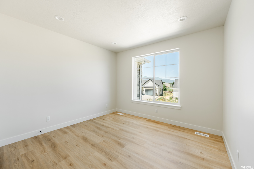 Spare room with light hardwood flooring