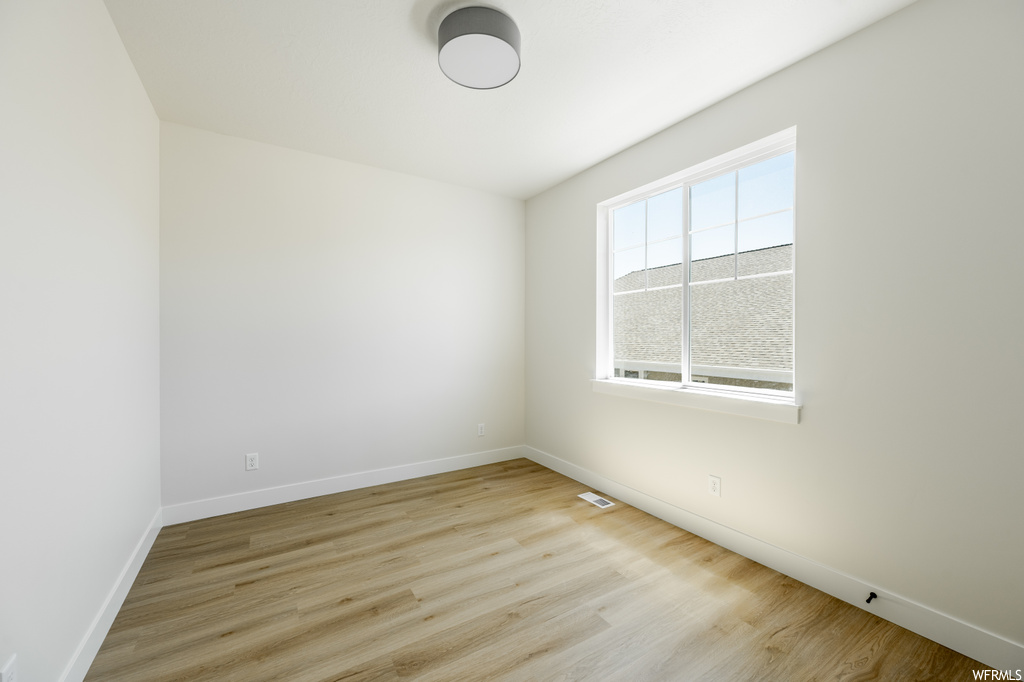 Empty room with light parquet floors