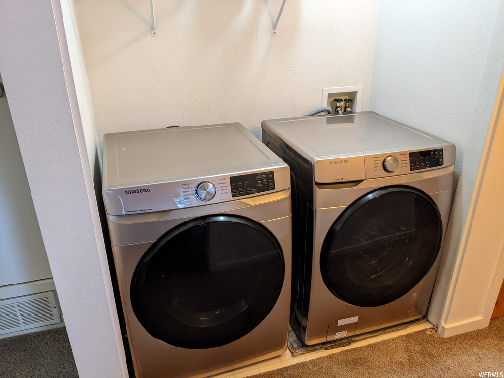 Washroom with independent washer and dryer and light carpet