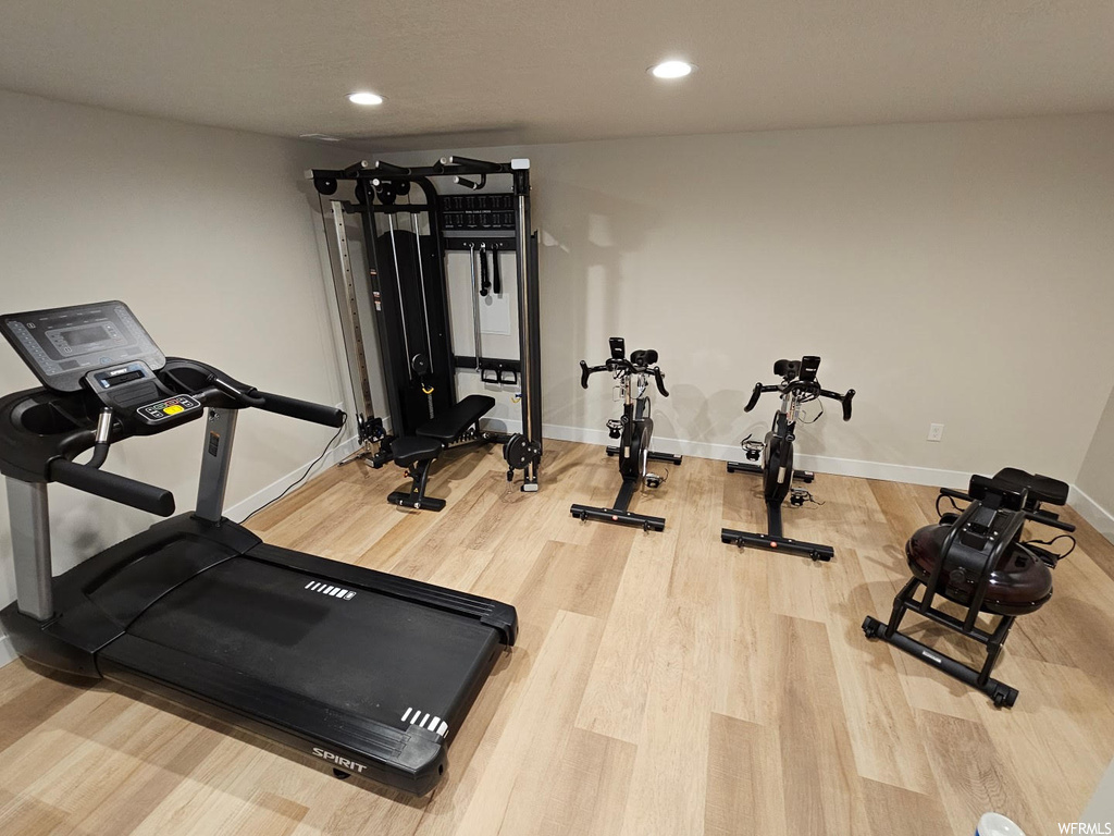 Workout room with light hardwood flooring