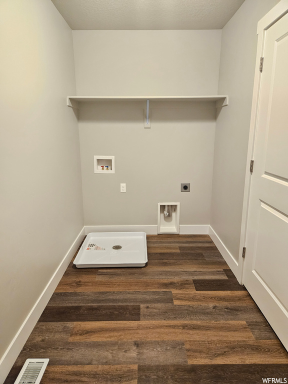 Laundry area featuring dark wood-type flooring, hookup for an electric dryer, and hookup for a washing machine